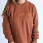 Handmade Sweater with fleece interior. Slits on the side for easy styling. Embroidered LATINA words on the front center