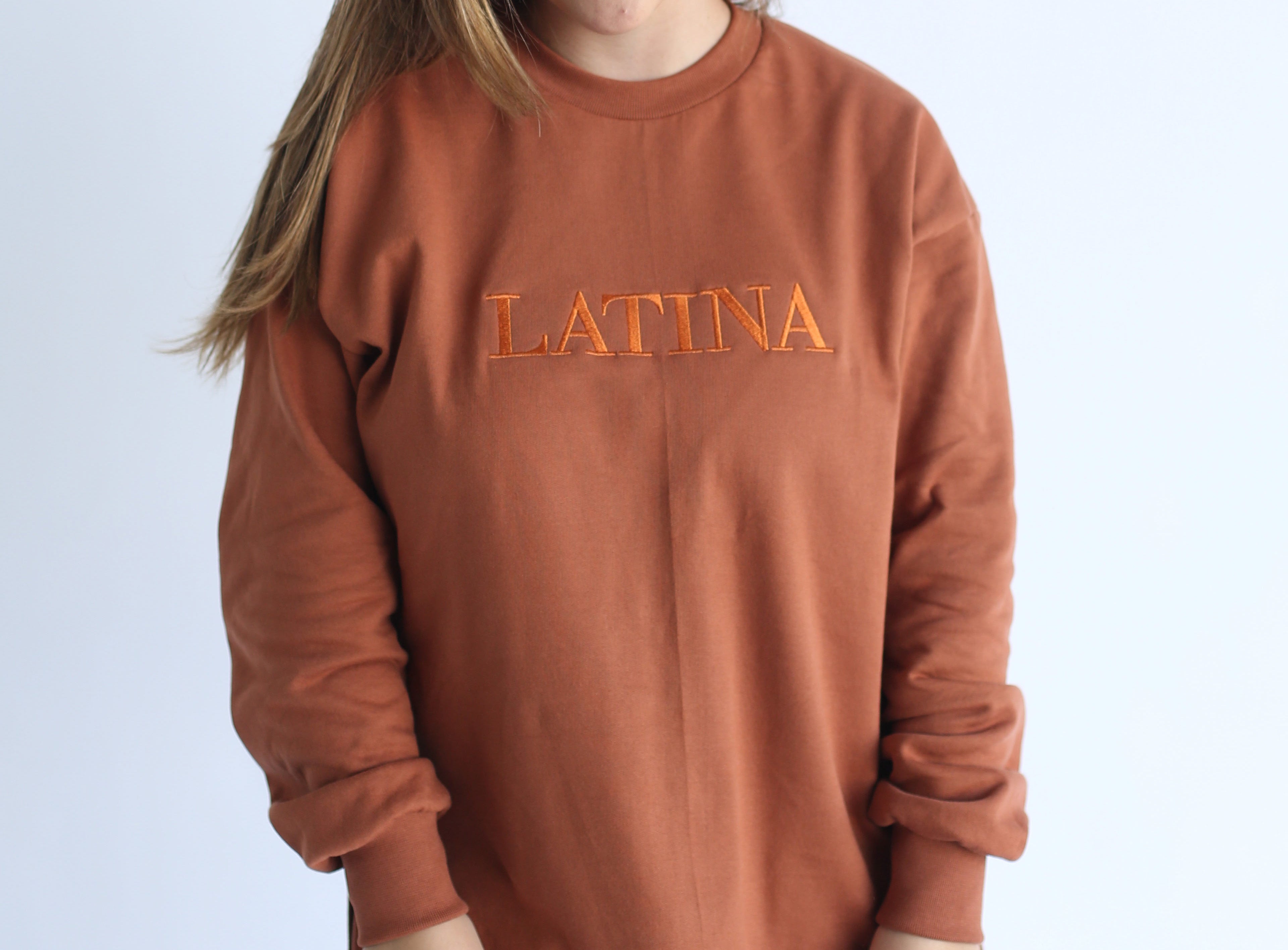 Handmade Sweater with fleece interior. Slits on the side for easy styling. Embroidered LATINA words on the front center
