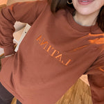 Handmade Sweater with fleece interior. Slits on the side for easy styling. Embroidered LATINA words on the front center