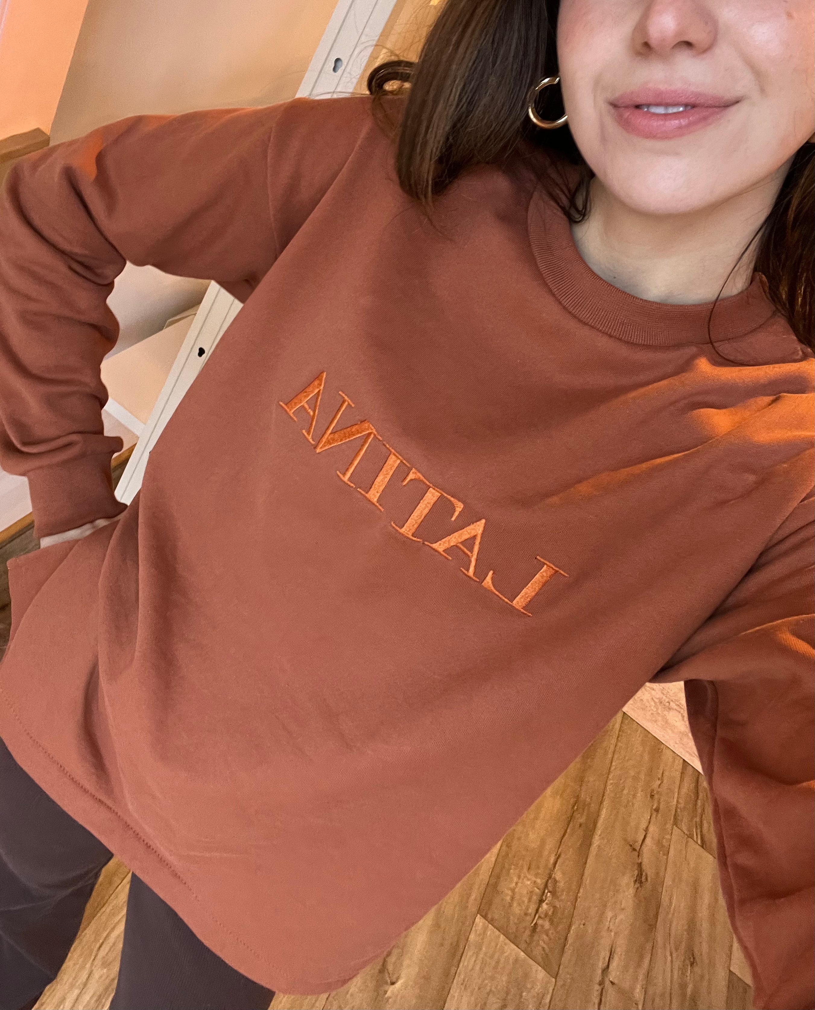 Handmade Sweater with fleece interior. Slits on the side for easy styling. Embroidered LATINA words on the front center