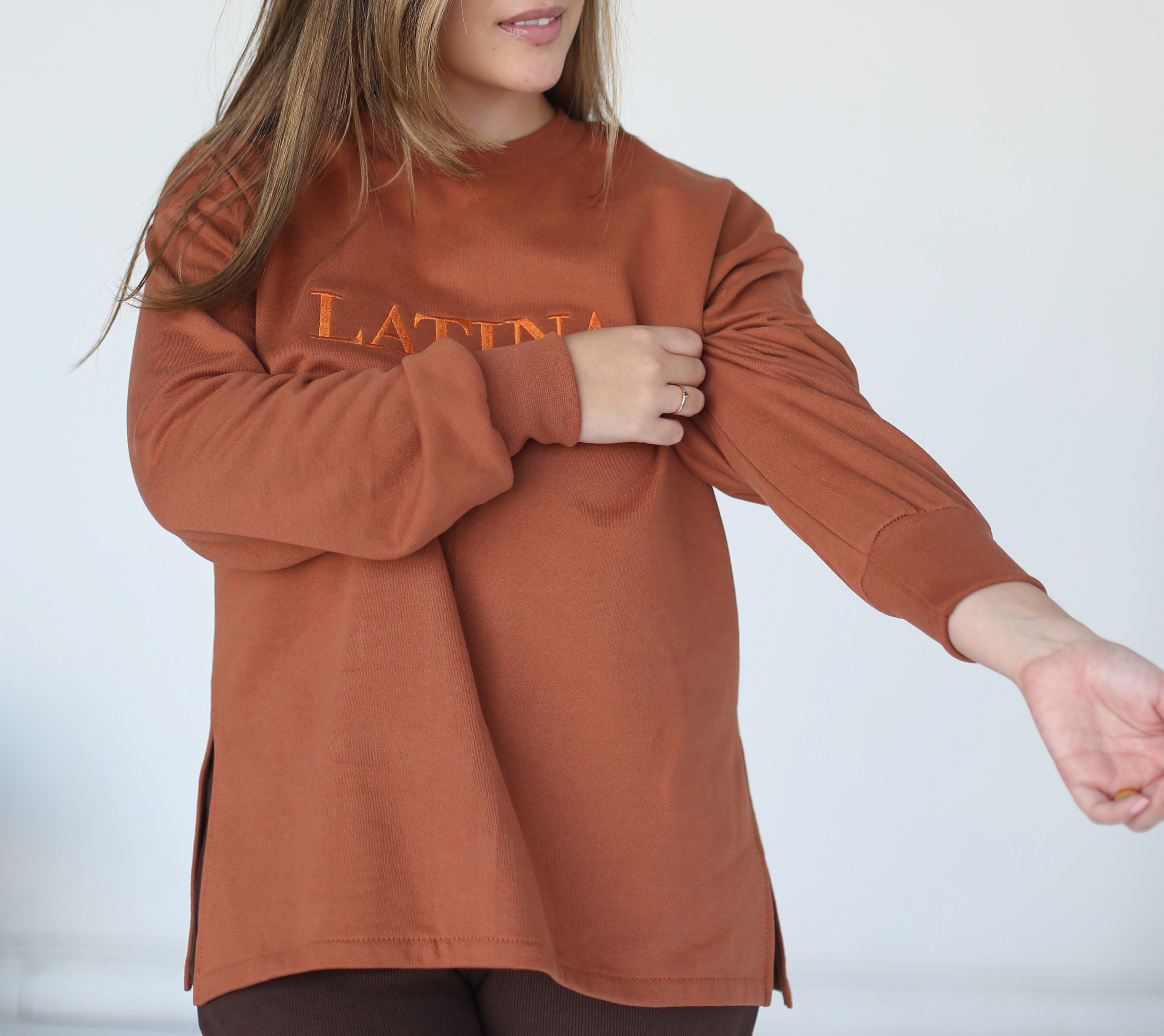 Handmade Sweater with fleece interior. Slits on the side for easy styling. Embroidered LATINA words on the front center