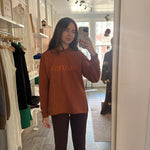 Handmade Sweater with fleece interior. Slits on the side for easy styling. Embroidered LATINA words on the front center